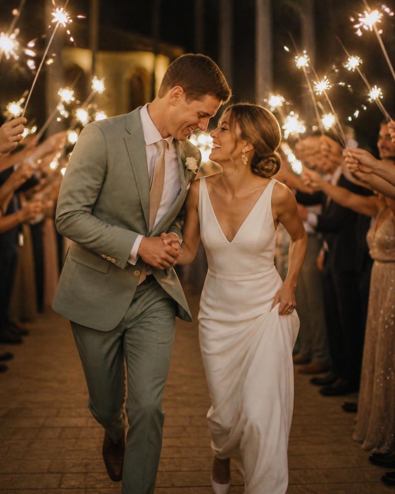 Emma and Will running through a sparkler tunnel