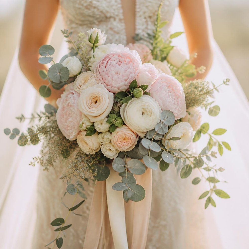 Bridal bouquet of blush peonies and garden roses